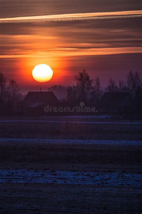 Sunset In A Cold Winter Evening Over A Meadow Stock Photo Image Of