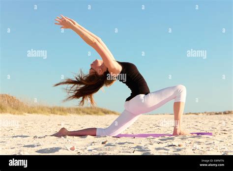Woman Doing Yoga On Beach Stock Photo Alamy