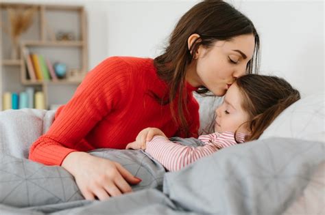 Premium Photo Mother Puts A Little Baby Girl To Sleep