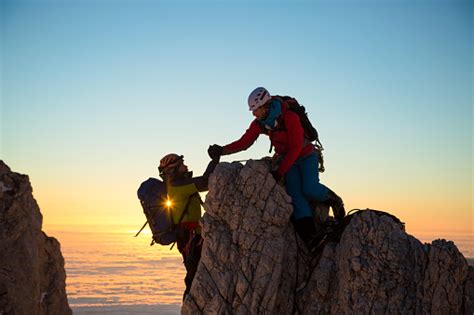 Two Men Climbing On Rock Stock Photo And More Pictures Of