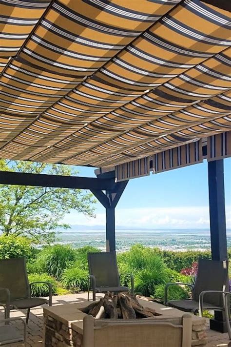 Striped Sunbrella Fabric Retractable Canopies On Wood Pergola Patio