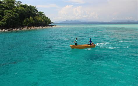 Two Person Sailing A Brown Canoe On Body Of Water Hd Wallpaper