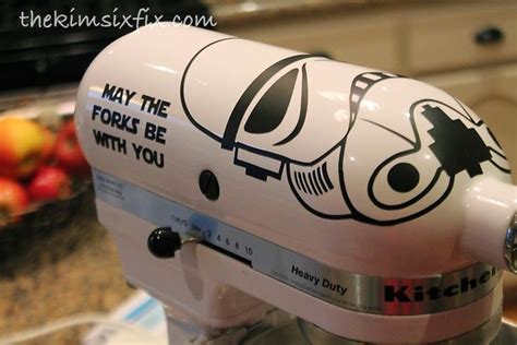 A Kitchen Aid Mixer With The Words May The Fork Be With You On Its Side