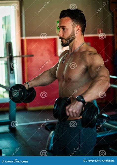 Attractive And Fit Young Man In Gym Working Out Pecs Stock Photo