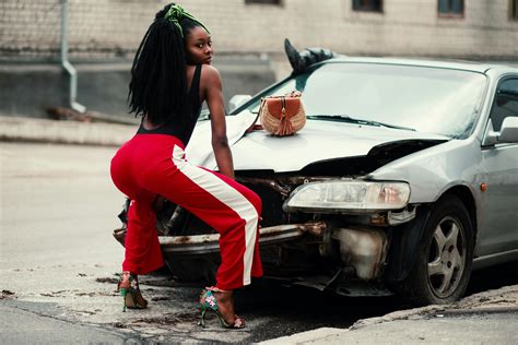 Photograph Of Woman About To Twerk In Front Of Vehicle · Free Stock Photo