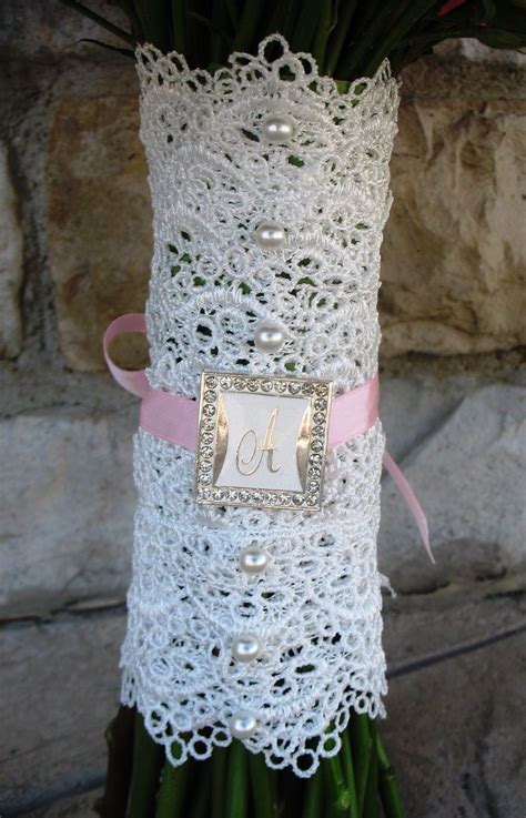 Tie a knot and a beautiful bow in the center of the wrap. Bridal bouquet with white lace wrap, white pearls ...