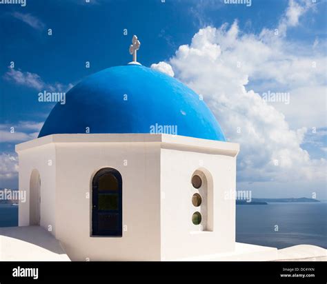 Beautiful Blue Domed Church Overlooking The Aegean Sea At Oia Santorini