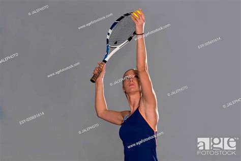 Portrait Of Female Tennis Player With Racket Ready To Hit A Tennis Ball Stock Photo Picture