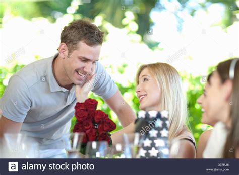 Man Giving Girlfriend Bouquet Of Flowers Stock Photo Alamy