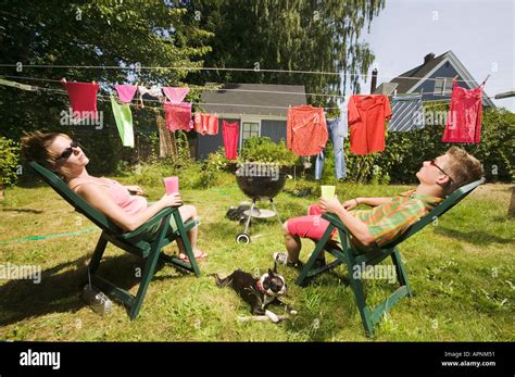 Couple Sunbathing In Back Yard Stock Photo Alamy