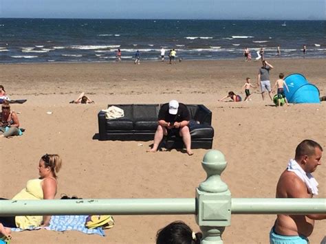 People Are Loving This Extreme Sunbather Sat On A Sofa On The Beach In