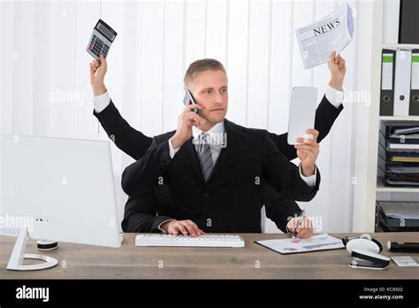 Busy Businessman Multitasking At Desk In Office Stock Photo Alamy