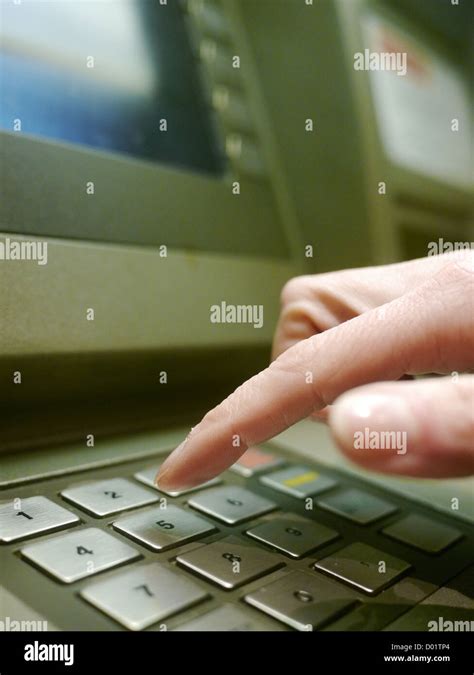 Finger Using Automatic Teller Keypad To Enter Pin Number Stock Photo