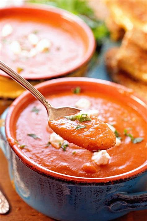 two bowls of tomato bisque soup topped with goat cheese and parsley tomato bisque recipe tomato