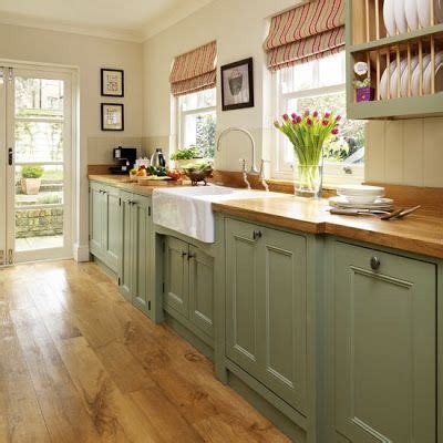 Have you ever thought of the colour sage green? Sage green lower cabinets, leave uppers in honey stained knotty pine. Dark wood floors and ...