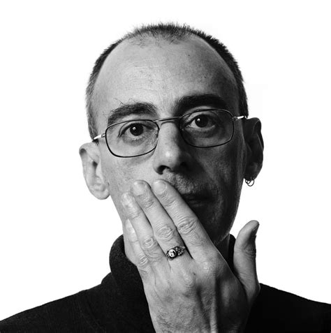 A Black And White Photo Of A Man With Glasses Holding His Hand To His Face