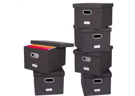 Four Black Storage Boxes Stacked On Top Of Each Other With File Folders