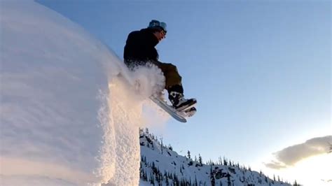 Look Pro Snowboarder Rides Off Cliff While Sitting Down Snowboarder
