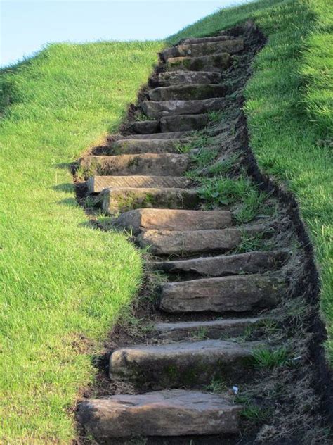 This document provides building code specifications, sketches, photographs, and examples of defects used in inspecting the platforms or landings used with indoor or outdoor stairs. Rock stairs winding up a grassy hill | Stairways, Exterior
