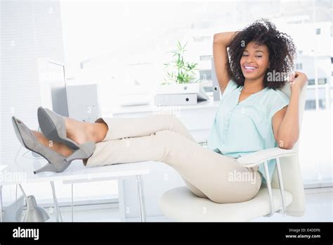 Happy Businesswoman Sitting With Her Feet Up Stock Photo Alamy