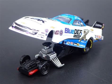 A Toy Car Is Shown On A Black Surface