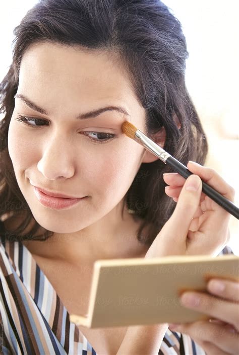 Beautiful Woman Applying Eyeshadow Makeup By Stocksy Contributor