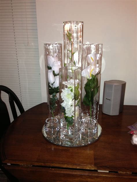 Vases Decorated With Silk Flowers Filled With Water And Floating
