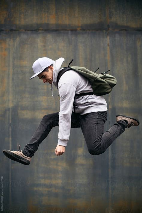 Young Man Jumping In Front Of An Urban Wall By Bonninstudio Man