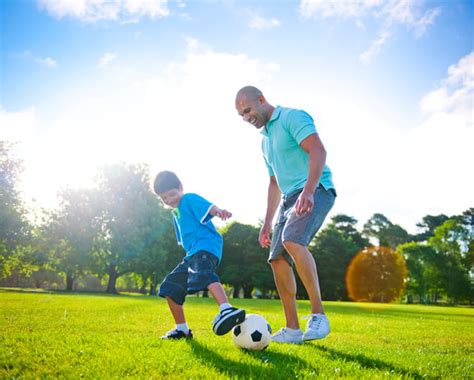 Stock Photo 19966198 Father And Son Playing Football Together1