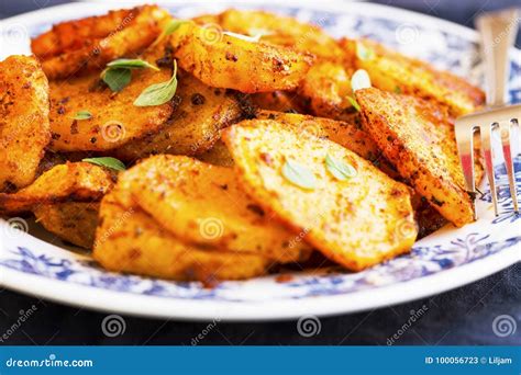 Round Slices Baked Potatoes With Spicy Condiments And Herb Leave Stock