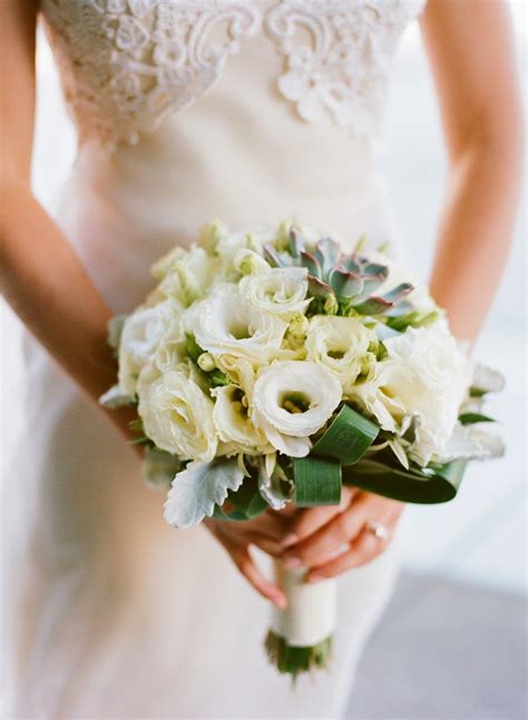 bouquet of white lisianthus with succulents and eucalyptus designed by florist meredith law