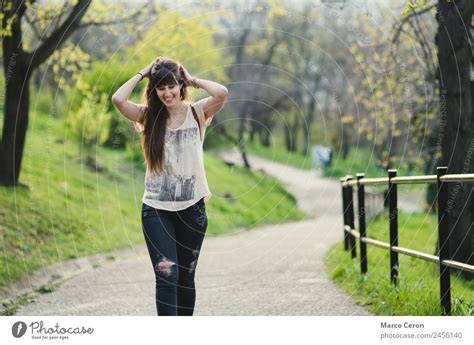 Beautiful Young Woman Smiling While Walking In The Park A Royalty