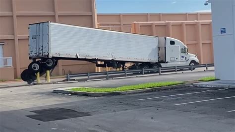 Semi Truck Loses Back Wheels Trying To Turn Around Safety Barriers