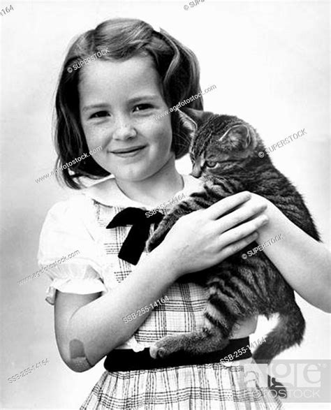 Girl Carrying A Cat Stock Photo Picture And Rights Managed Image Pic