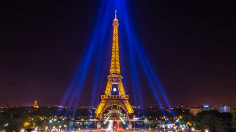Yellow Lighting Paris Eiffel Tower Around Blue Lights With Black Sky