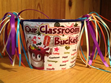 An Ice Cream Bucket Is Decorated With Colorful Streamers And Ribbons For The Classroom Bucket
