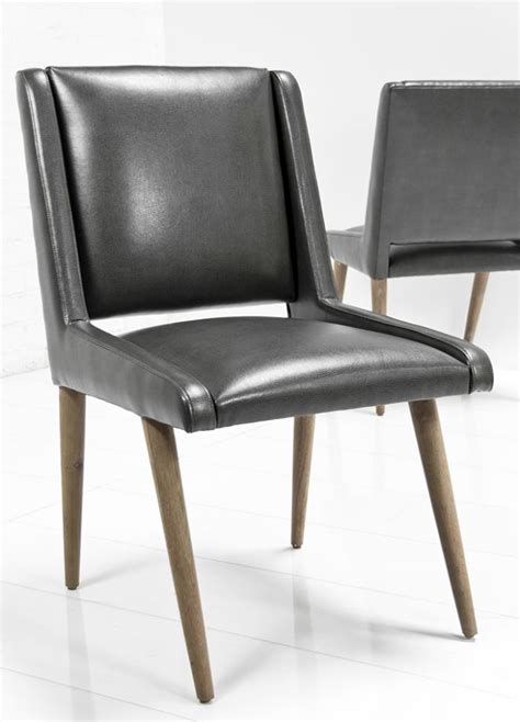 Chair is covered in a top grain leather and leather match application in a charcoal color. www.roomservicestore.com - Mid Century Dining Chair in Charcoal Faux Leather