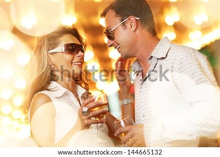 Adult Couple Enjoying Nightlife With Glasses Of Champagne Shallow Dof