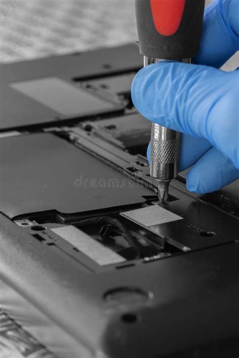 Technician Installing Hard Drive Hdd To A Laptop Computer Using