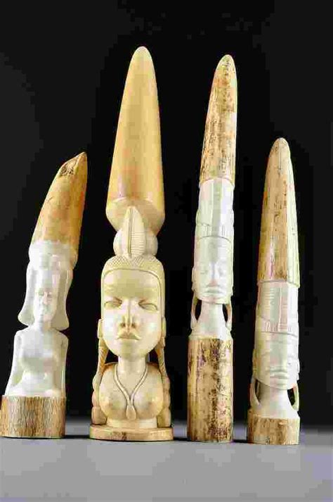 128 A Group Of Four African Ivory Carvings Of Native M