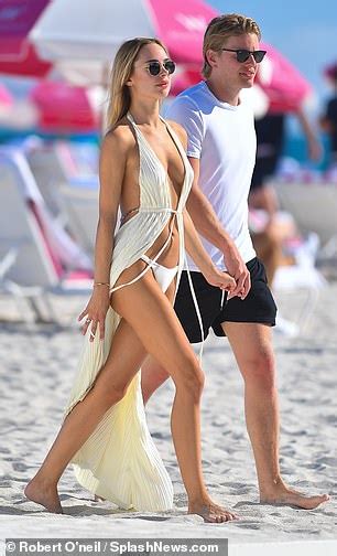 Kimberley Garner Wows In A Racy Plunging Cover Up As She Enjoys Cosy Beach Stroll With Beau