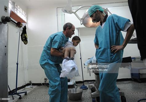 Algerian Doctors Prepare A Boy To Be Circumcised During A Mass Photo