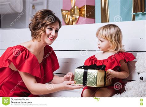 Mother And Her Daughter Exchanging Christmas Ts Stock Photo Image