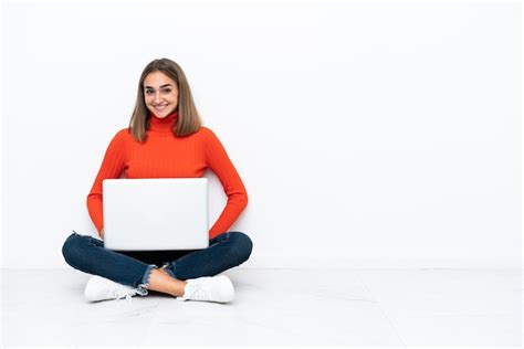 Premium Photo Young Woman With A Laptop Sitting On The Floor Pointing
