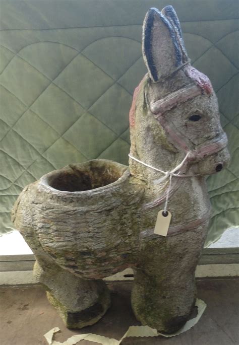 A Statue Of A Donkey With A Tag On Its Collar