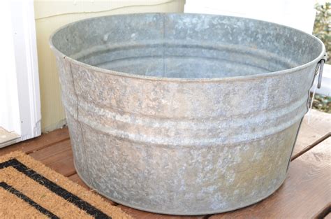 Decide where you want on your faucet tub and cut holes to match requirements of faucets, with a. IRON & TWINE: Galvanized Tub