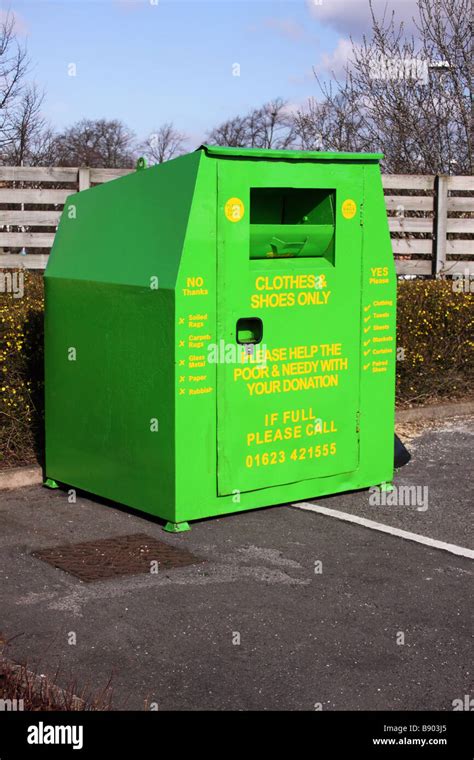 Green Clothing Textiles Recycling Bin Located In A Car Park Stock Photo