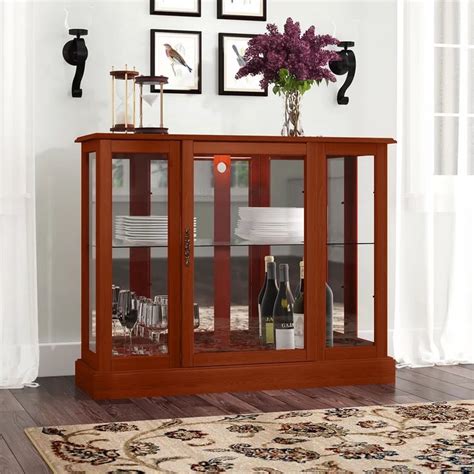 Three adjustable glass shelves, touch lighting, option to add lock and a modern twist on the beloved curio cabinet. Franklyn Lighted Console Curio Cabinet | Wall curio ...