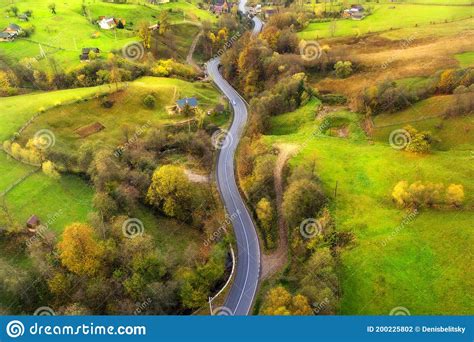 Aerial View Of Beautiful Winding Road In Green Hills Stock Photo