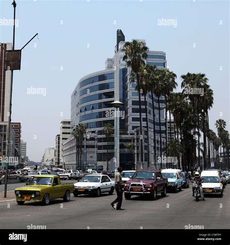 A Man Crosses A Busy Street In Downtown Harare Zimbabwe Stock Photo